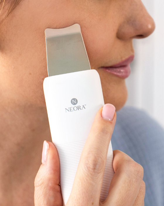 Woman using Neora’s Ultrasonic Skin Renewal Facial Device on her face